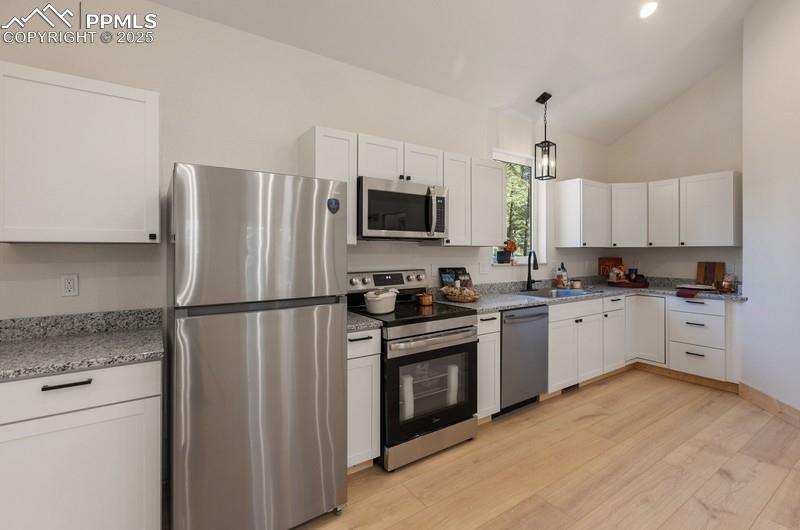 Image 13 of 37: Kitchen with appliances with stainless steel finishes, Granite Countertops,