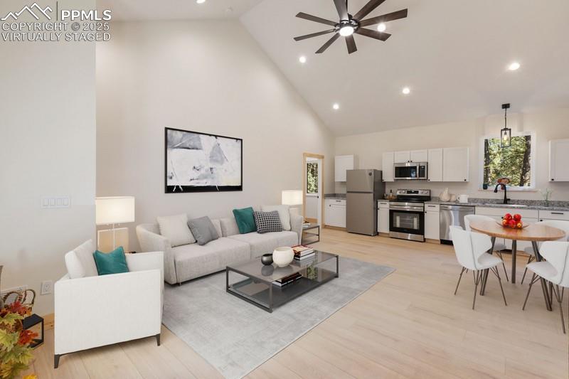 Image 15 of 37: Virtually Staged Living area with high vaulted ceiling, recessed lighting, 