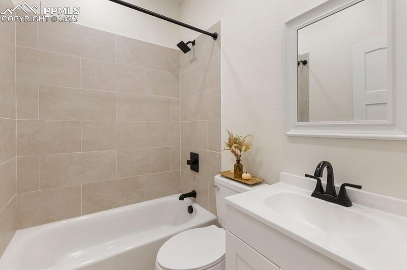 Image 18 of 37: Bathroom featuring bathtub / shower combination and vanity