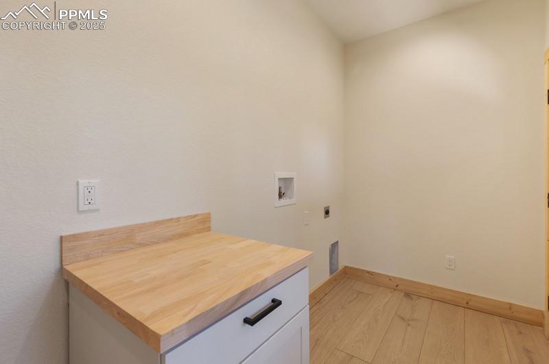 Image 19 of 37: Laundry area featuring light wood-type flooring, hookup for a washing machi