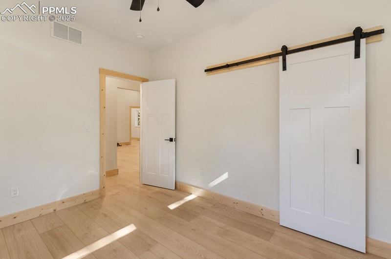 Image 22 of 37: Bedroom #2 from 2nd angle featuring light wood-style flooring, ceiling fan,