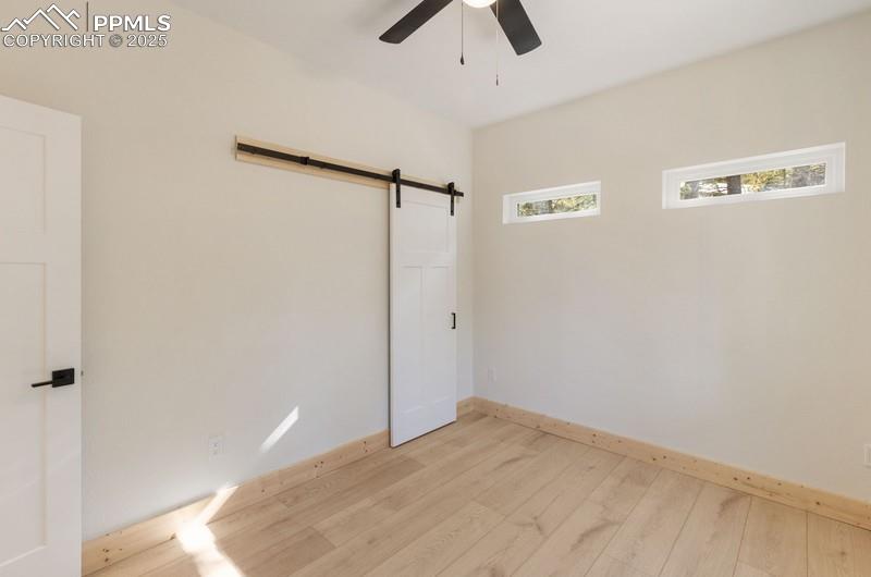 Image 23 of 37: Bedroom #2 from 3rd angle featuring hardwood / wood-style floors, a barn do