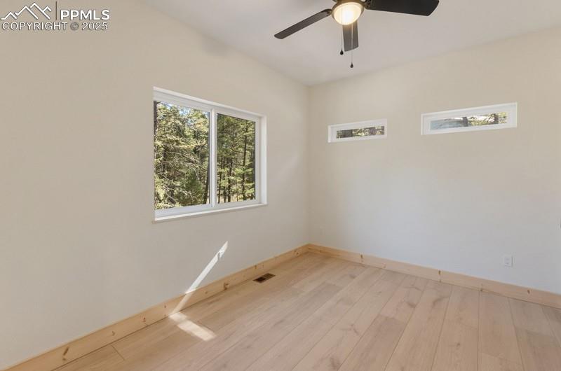 Image 26 of 37: Laundry room featuring light wood-type flooring and ceiling fan