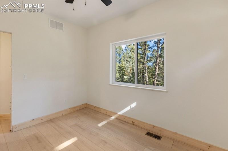 Image 27 of 37:  Bedroom #3 from a 2nd angle featuring light wood finished floors and a cei