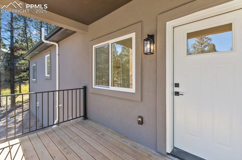 Image 32 of 37: Entrance to property with stucco siding