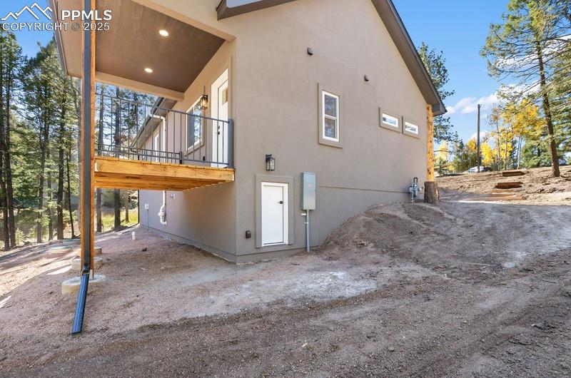 Image 4 of 37: View of side of property with stucco siding