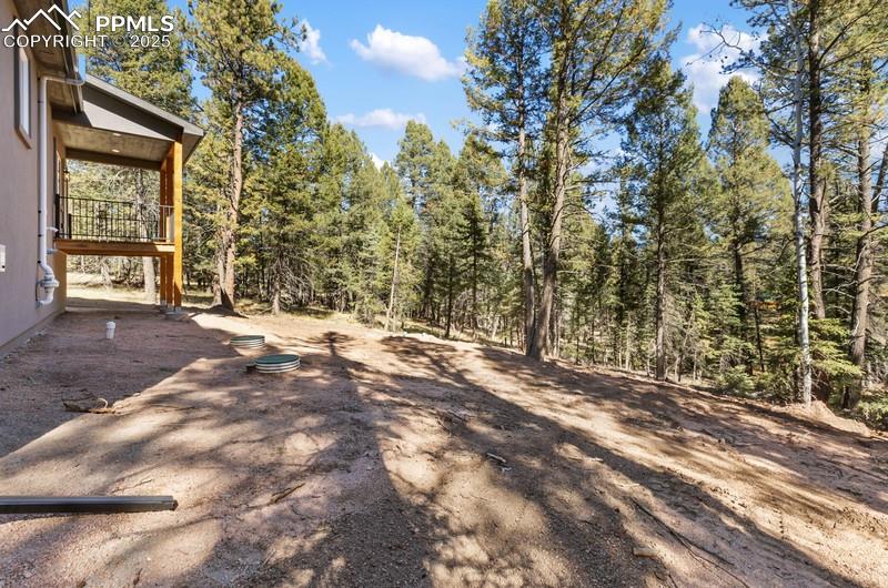 Image 7 of 37: View of yard featuring a wooded view