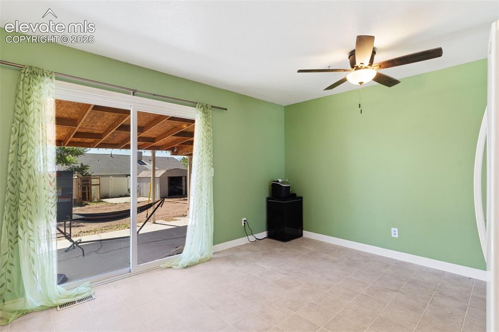 Image 14 of 36: Room featuring tile flooring, a ceiling fan with integrated lighting, and a