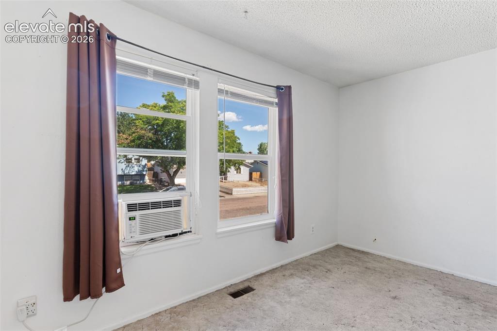 Image 15 of 36: Bright interior space featuring light-colored walls and soft carpeting