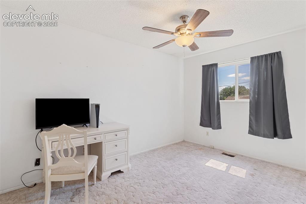Image 18 of 36: Bright interior space featuring white walls, textured carpeting, and a ceil