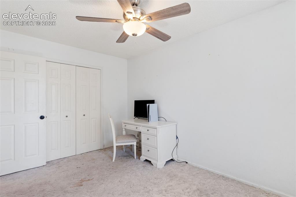 Image 20 of 36: Spacious bedroom featuring neutral carpeting, a ceiling fan with integrated