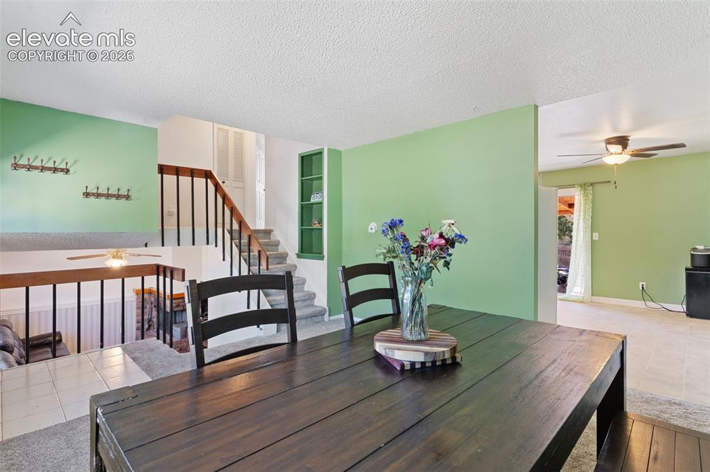 Image 7 of 36: Dining area featuring a dark wood-finish table, light green accent walls, a