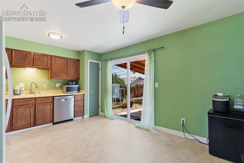 Image 9 of 36: Kitchen featuring wood cabinetry, light countertops, and a stainless steel