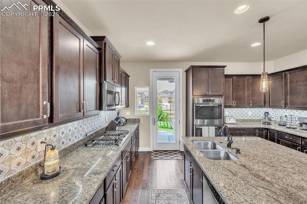 Image 11 of 40: Kitchen opens to back patio for grilling and backyard relaxation