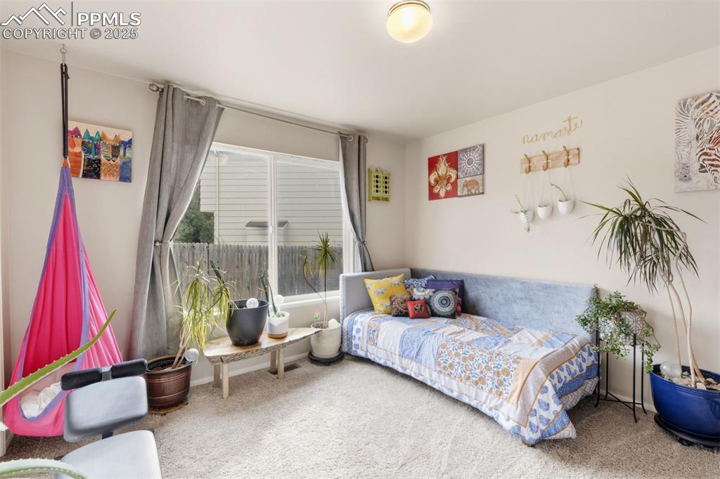 Image 13 of 46: The main level bedroom makes a great guest bedroom, or home office. 