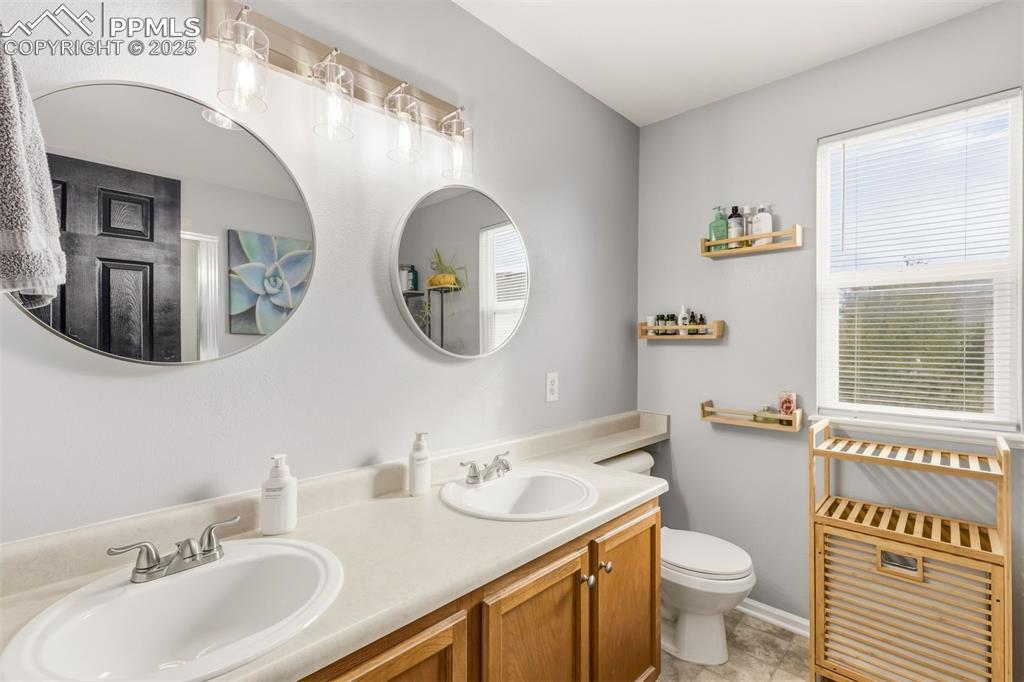 Image 21 of 46: Primary bathroom with double vanity.