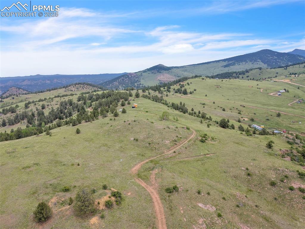 Image 2 of 9: Overview of rural landscape with a mountain backdrop