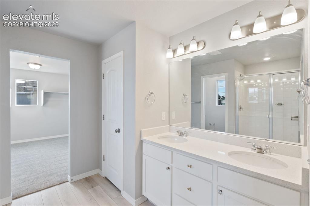 Image 14 of 26: Primary master bath with double vanities quartz countertops