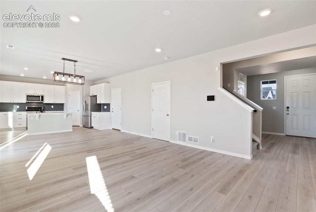 Image 4 of 26: Front Entry, Living, dinning and kitchen
