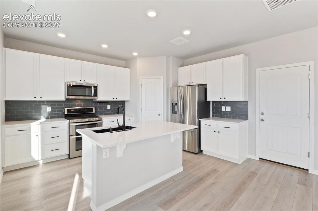 Image 5 of 26: Kitchen with stainless steel appliances