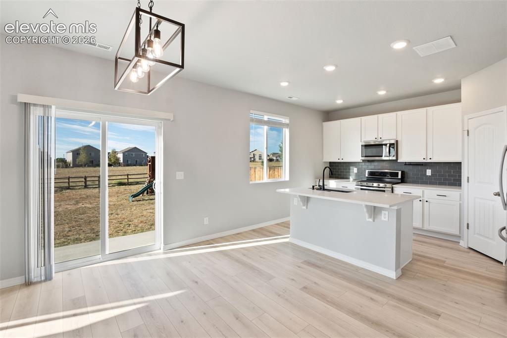 Image 8 of 26: Kitchen with eating bar on quartz countertop