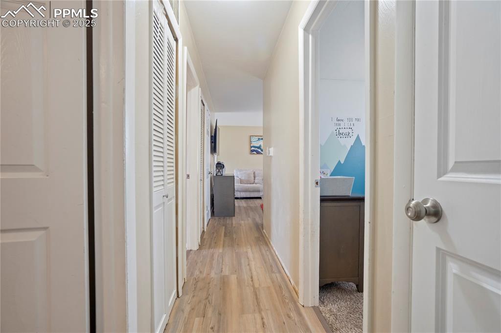 Image 10 of 22: Corridor with light wood finished floors