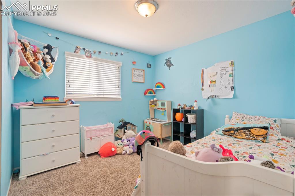 Image 16 of 22: Bedroom with carpet flooring