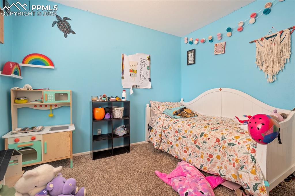 Image 17 of 22: Carpeted bedroom with baseboards