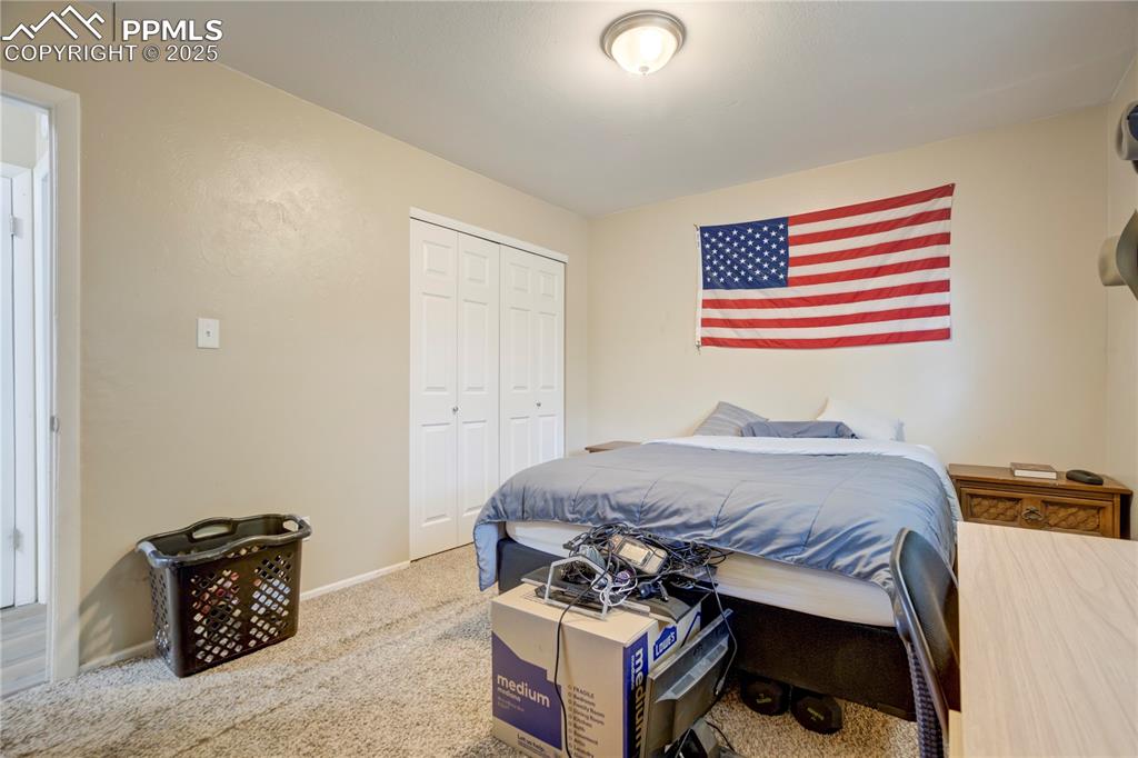 Image 19 of 22: Bedroom with carpet floors and a closet
