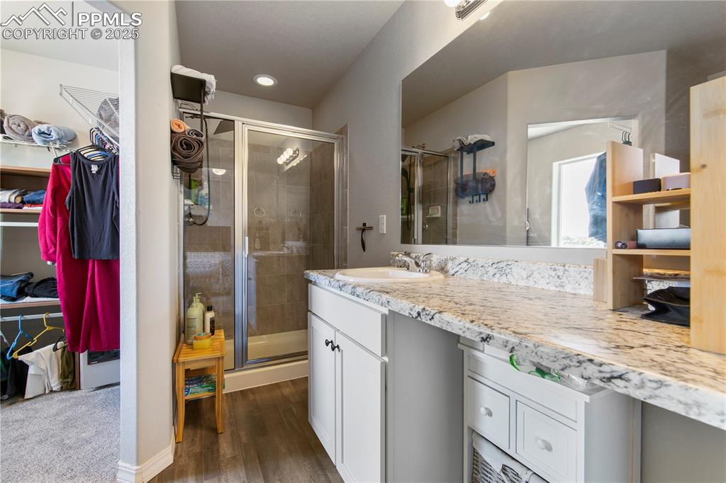 Image 20 of 36: 3/4 primary bath has a large walk in closet.