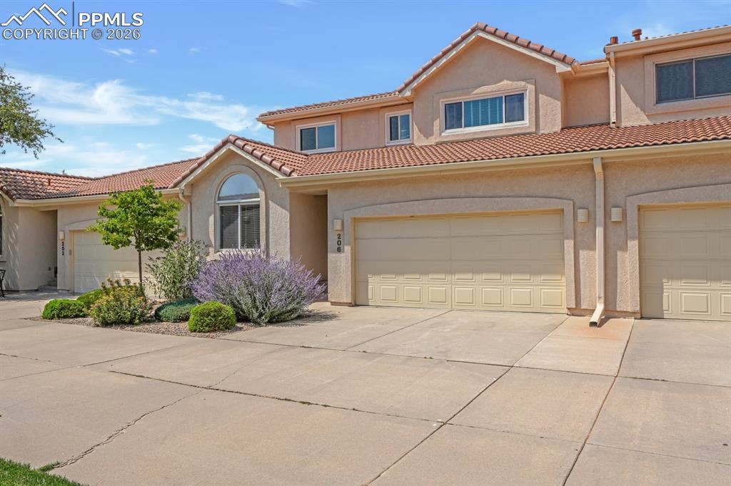Caption: Mediterranean Style home with stucco siding and tiled roof