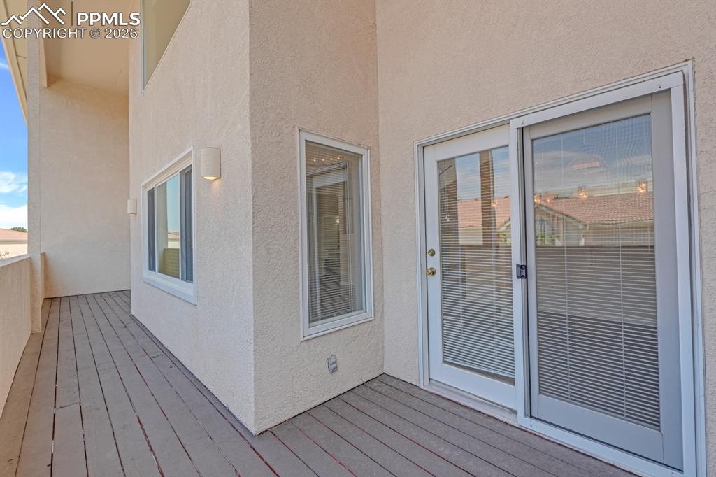 Image 13 of 43: Wooden deck with stucco railing