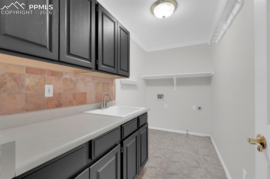 Image 17 of 43: Laundry area with cabinet space on main level