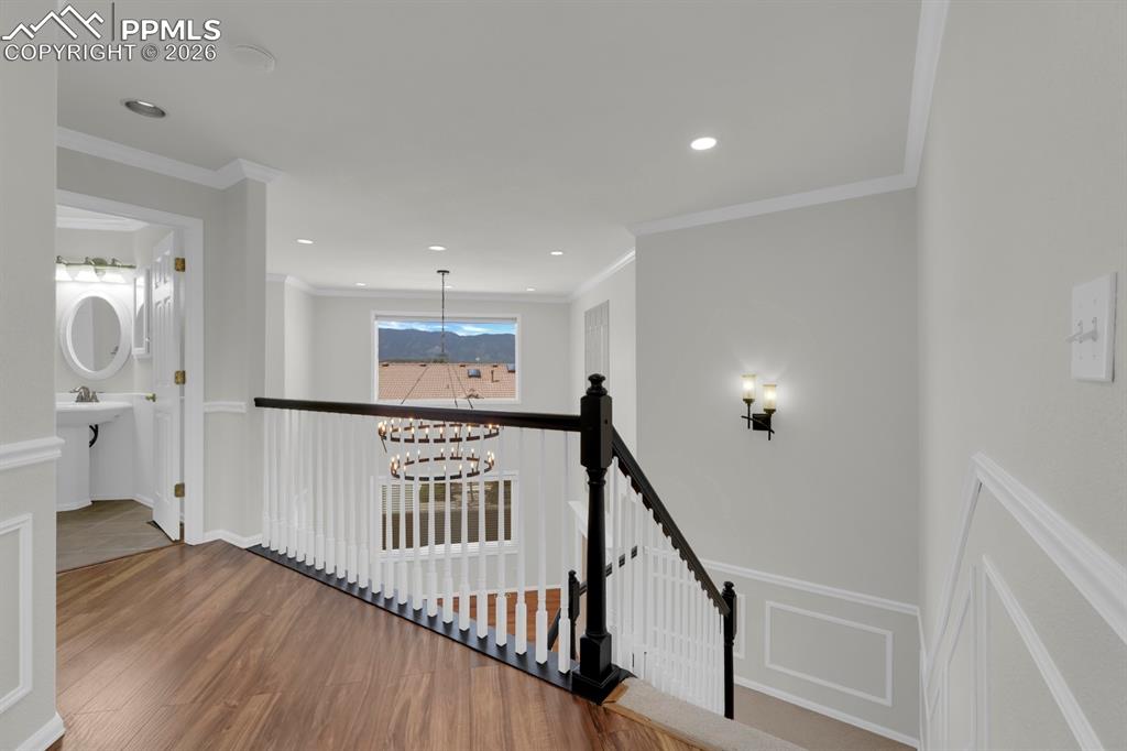 Image 18 of 43: Stairway to upper level featuring wood finished floors