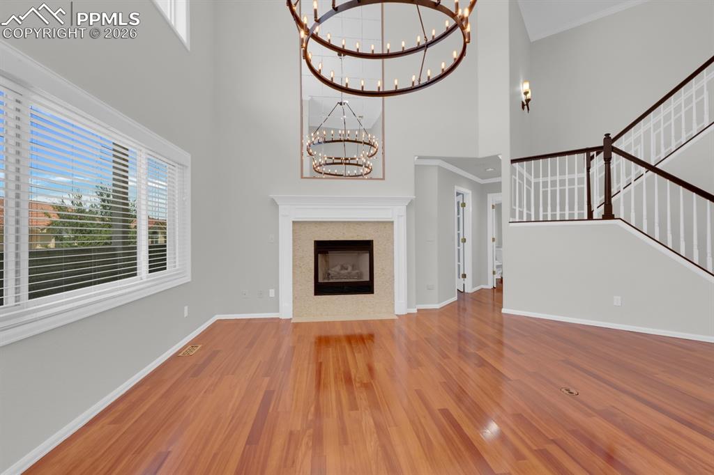 Image 7 of 43: Living room featuring a gas fireplace with custom rock mantle