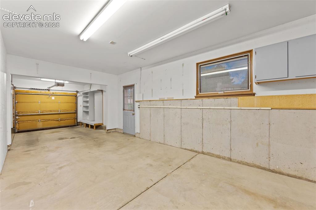 Image 33 of 43: 39 x 11 finished garage with service door