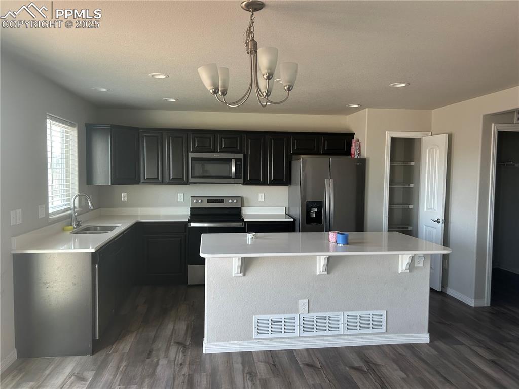 Image 2 of 10: Kitchen featuring appliances with stainless steel finishes, a kitchen islan