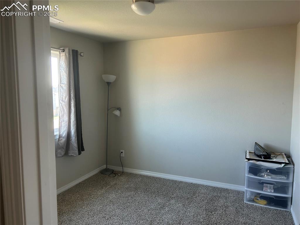 Image 8 of 10: Carpeted spare room featuring baseboards