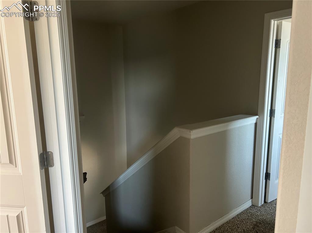 Image 9 of 10: Hall with carpet floors and baseboards