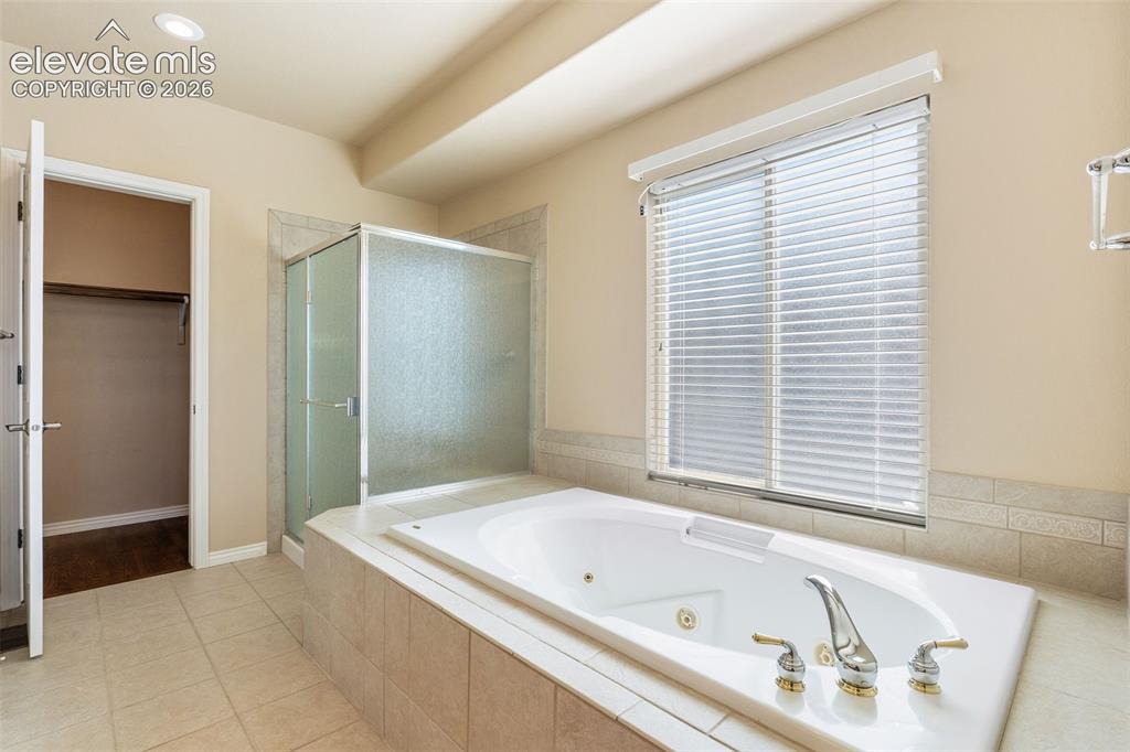 Image 22 of 50: PRIMARY ENSUITE BATHROOM WITH JETTED SOAKING TUB AND WALK IN SHOWER