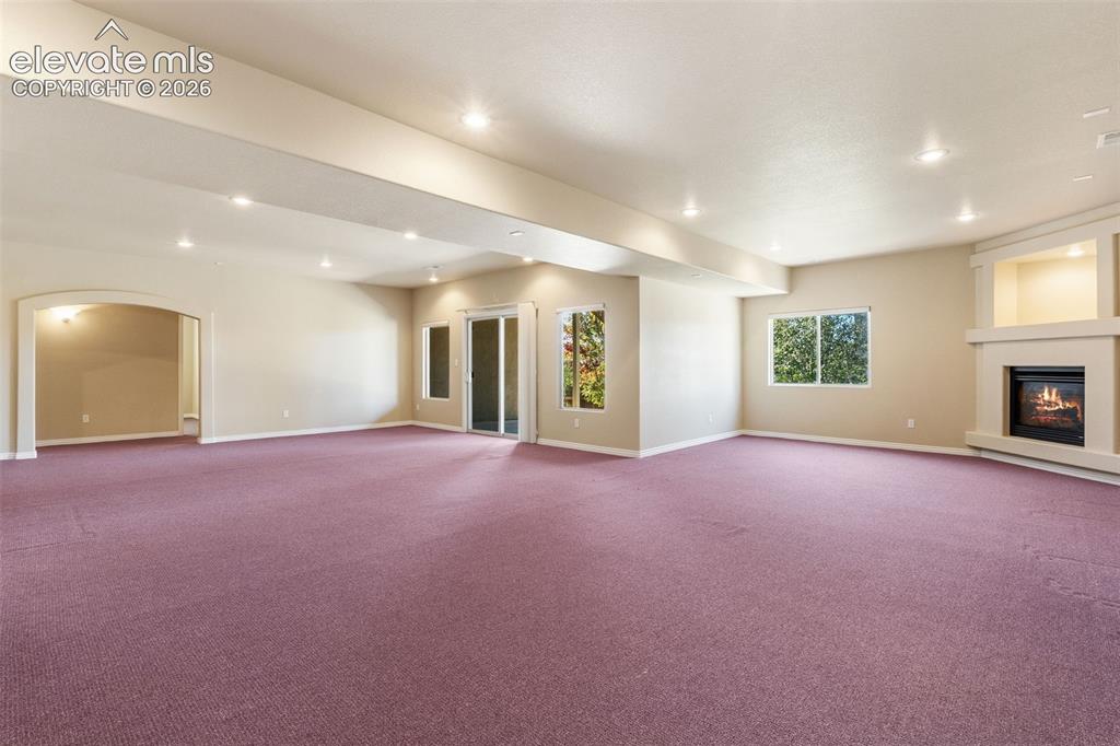 Image 31 of 50: BASEMENT WITH WALK OUT AND FIREPLACE