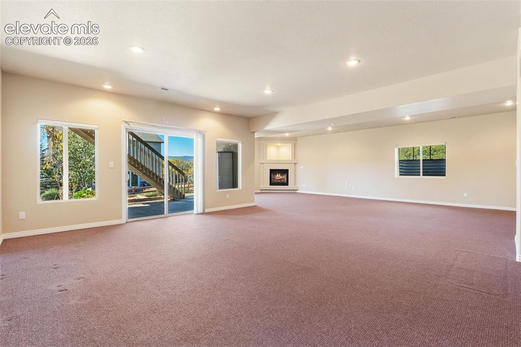 Image 33 of 50: SPACIOUS BASEMENT HAS WALK OUT AND COVERED PATIO