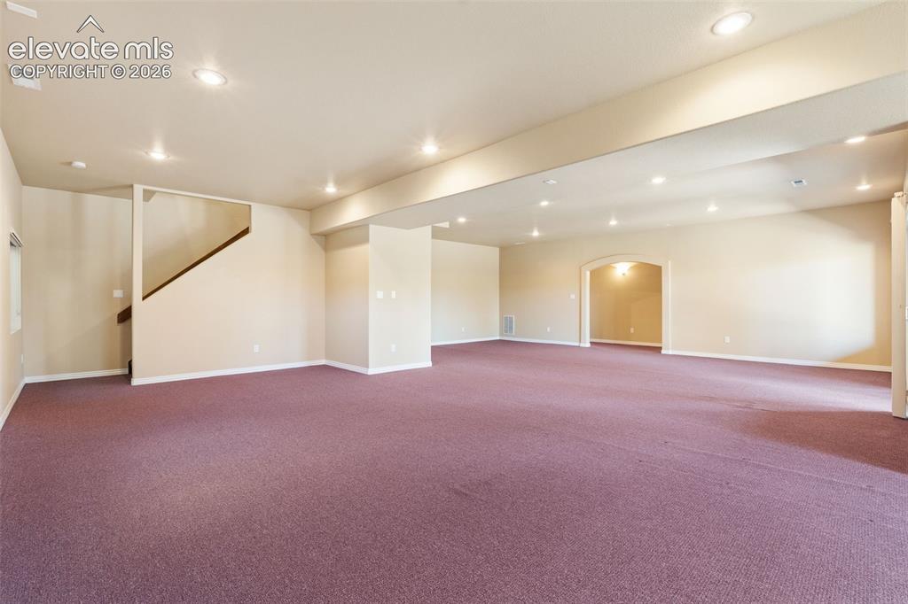 Image 34 of 50: Open-concept interior featuring recessed lighting, plush wall-to-wall carpe