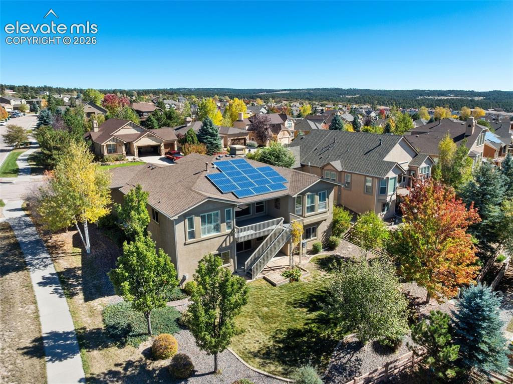 Image 42 of 50: Multi-level exterior featuring installed solar panels, a raised upper deck,