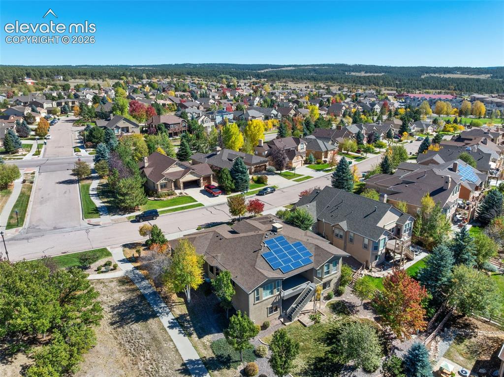Image 43 of 50: Aerial perspective featuring a multi-level residence with a roof-mounted so