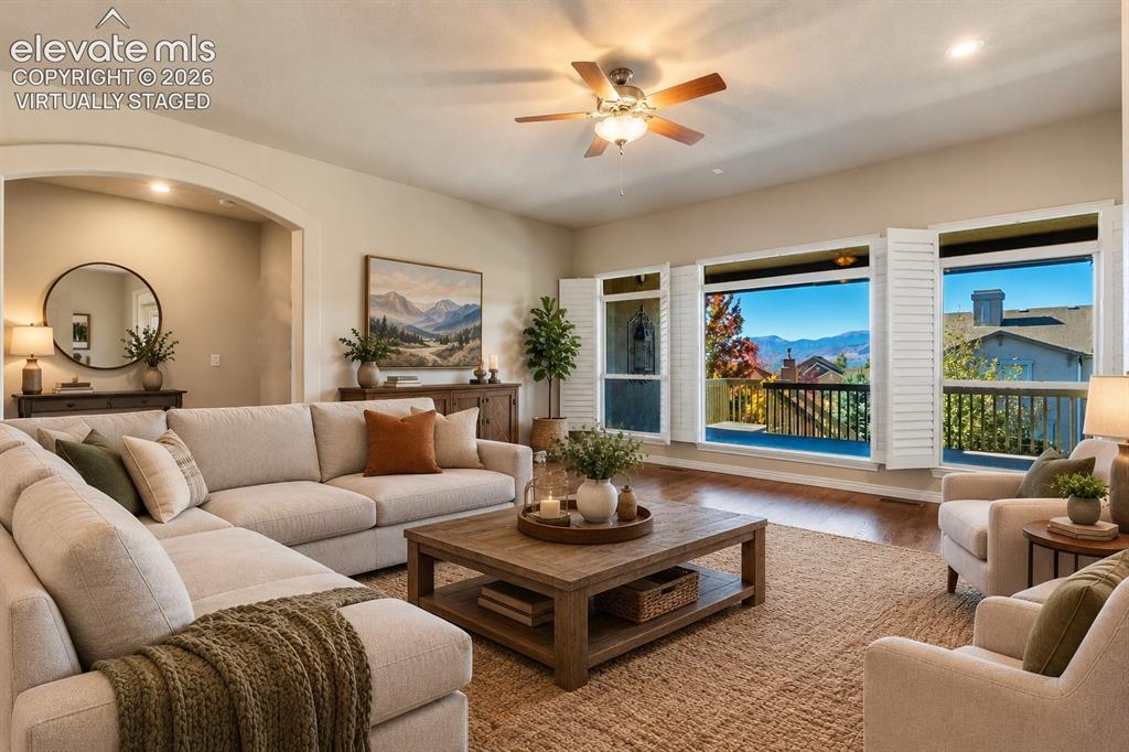 Image 8 of 50: VIRTUALLY STAGED - LIVING ROOM WITH AMAZING VIEWS OF PIKES PEAK
