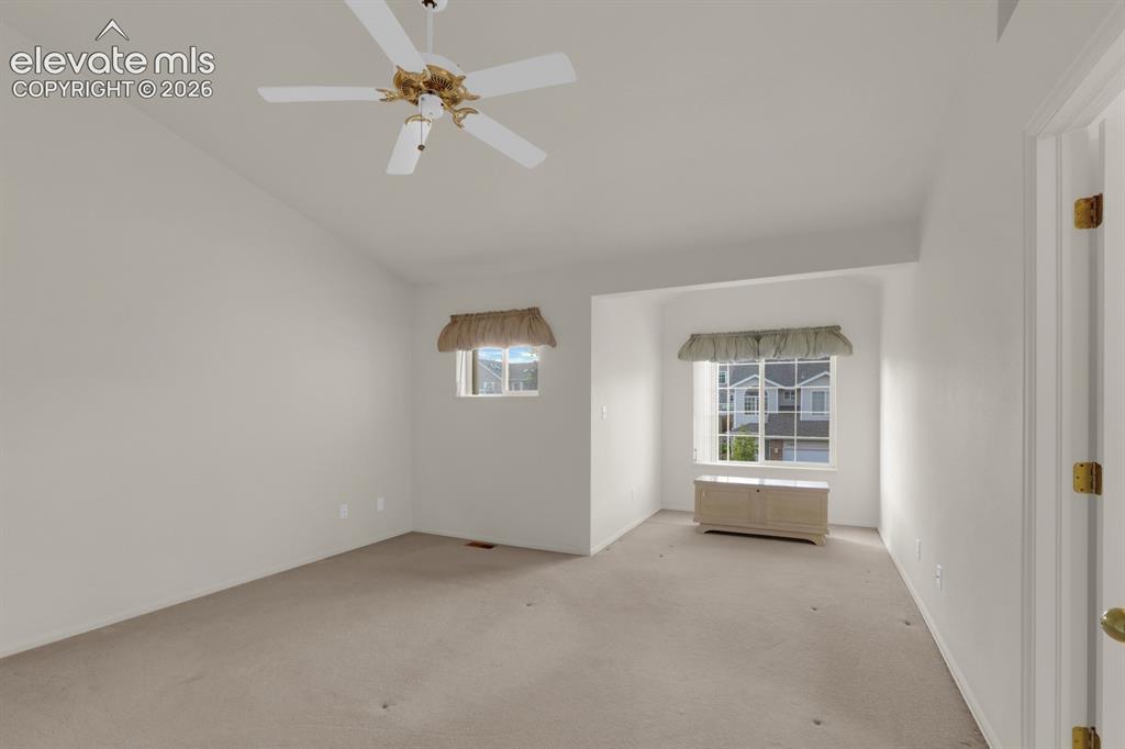 Image 13 of 30: Primary bedroom w/ vaulted ceilings