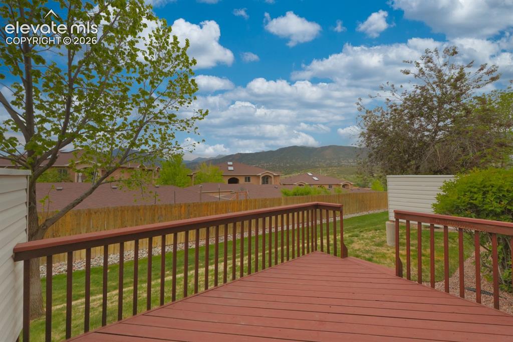 Image 29 of 30: Expansive outdoor deck overlooking open area