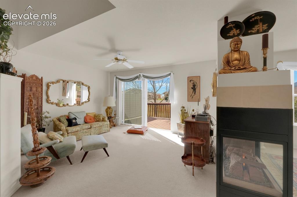 Image 3 of 30: Living area with fireplace