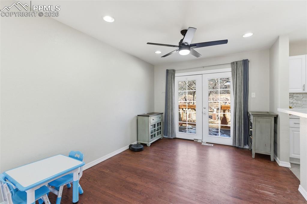 Image 11 of 50: Unfurnished dining area featuring dark wood-style flooring, recessed lighti
